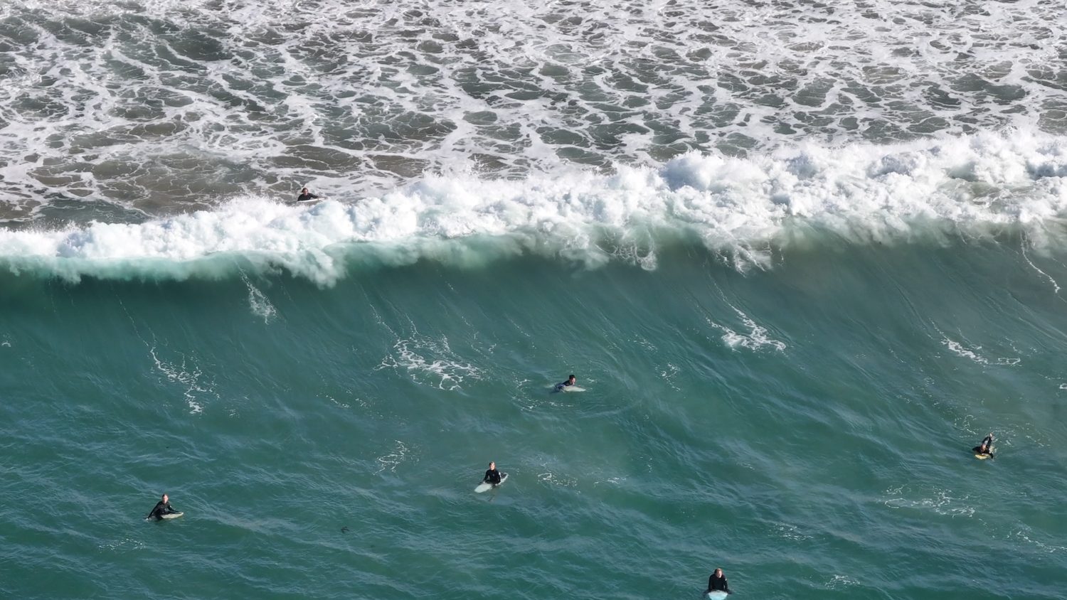 Drone view of waves and surfers